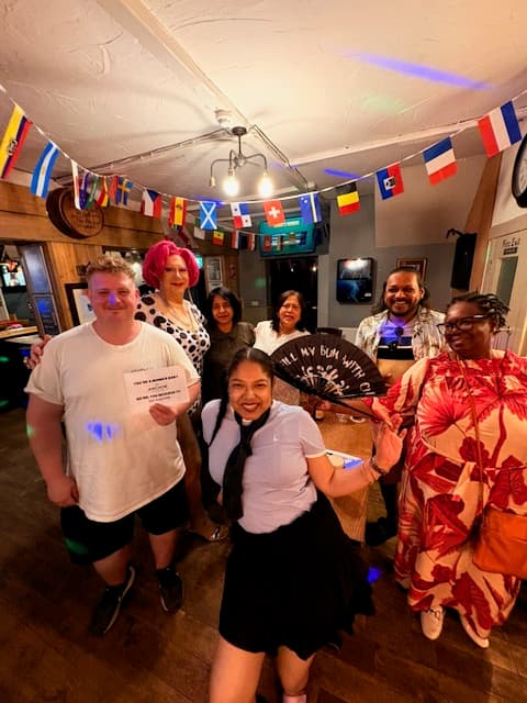 A group standing with drinks at music bingo at The Anchor