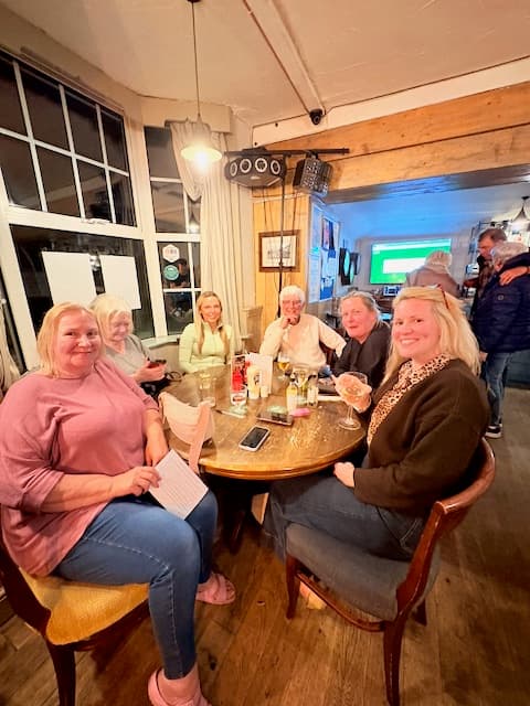 Quiz players with food and drinks on the table before the first round