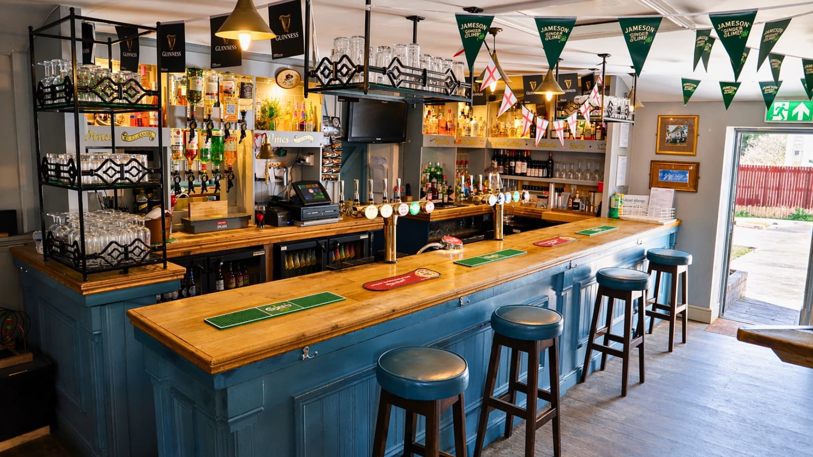 Fully stocked bar at The Anchor with draught taps, spirits and gin collection