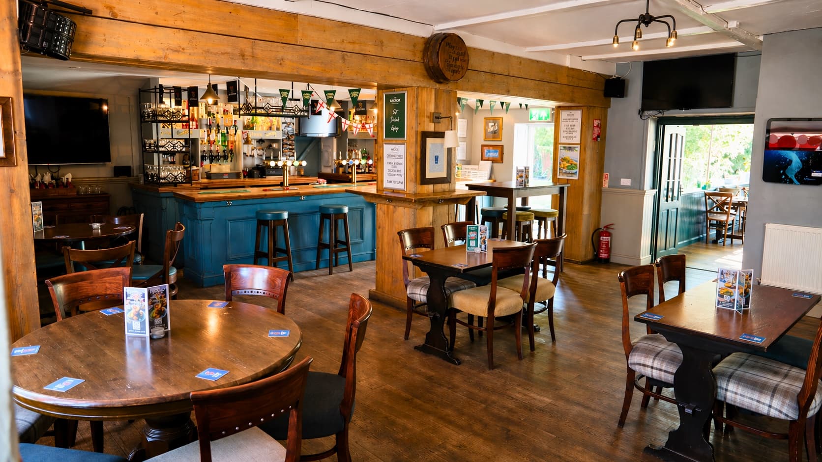 Main bar area at The Anchor with dartboard and jukebox
