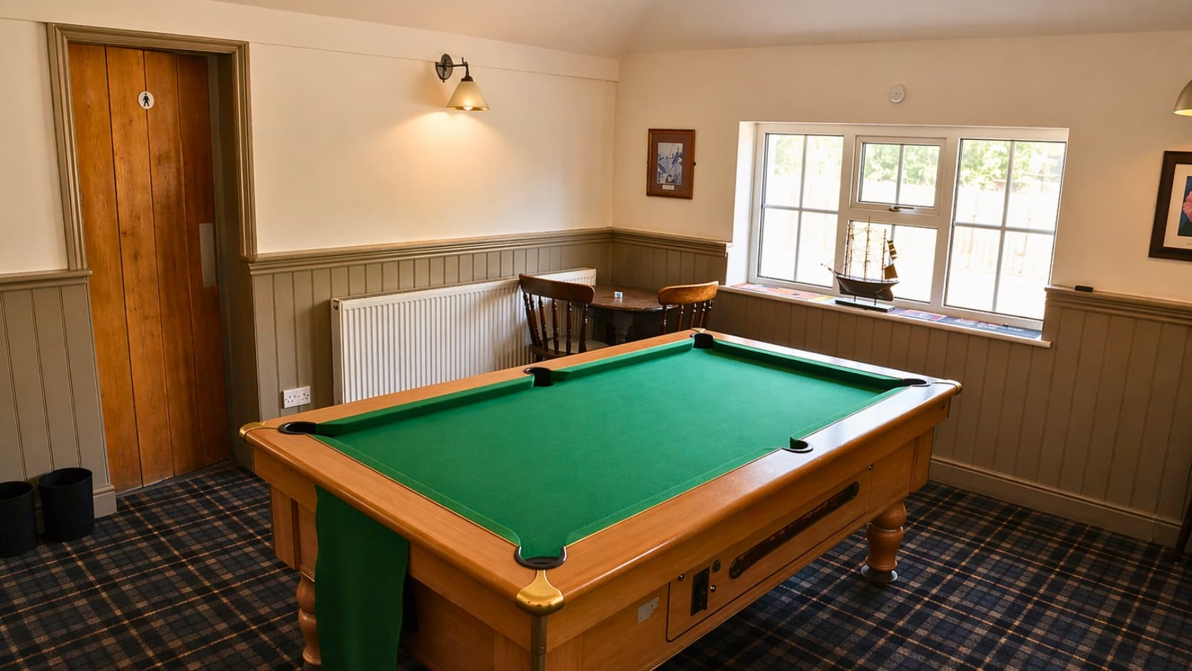 Bay window seating near the pool table at The Anchor, perfect for a quieter meal