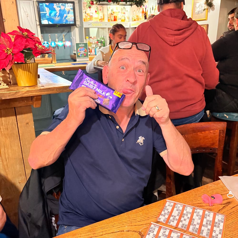 Guest celebrating with a chocolate prize at The Anchor